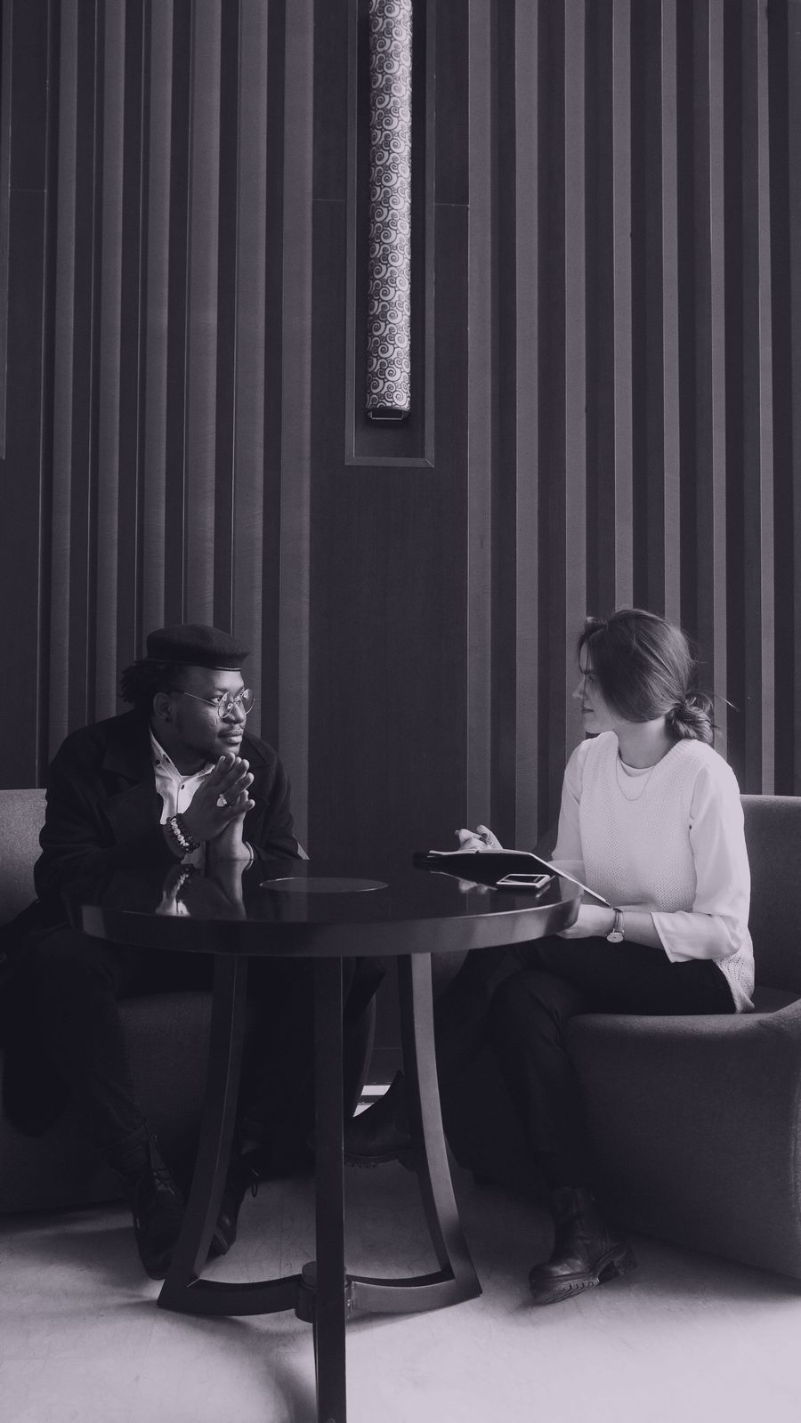 Two professionals in conversation across a table